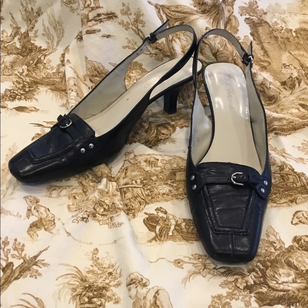 Sleek and comfy buckle black leather slingbacks.